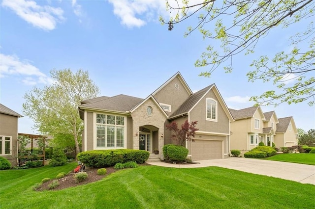traditional-style house with stucco siding, driveway, a front yard, and a garage