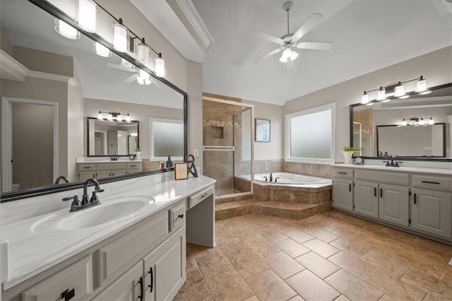 full bath featuring a garden tub, lofted ceiling, ceiling fan, a shower stall, and a sink