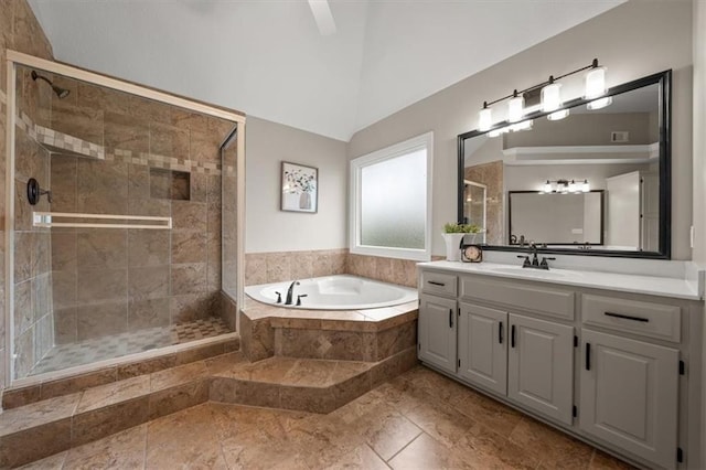 full bathroom featuring vaulted ceiling, a shower stall, a bath, and vanity