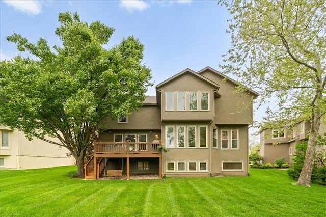 back of house with a lawn, a deck, stairs, and stucco siding