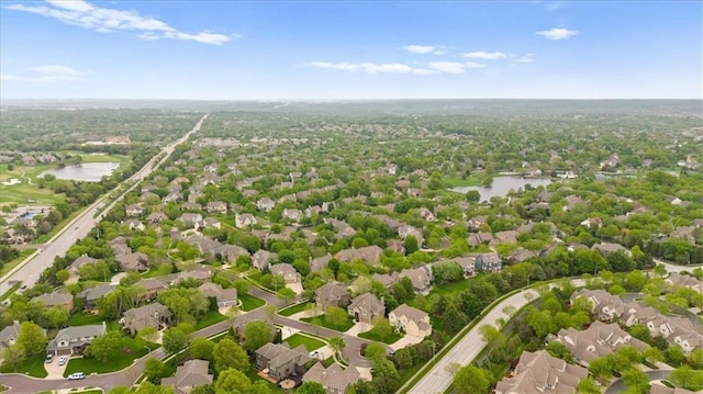 drone / aerial view with a water view and a residential view