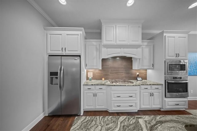 kitchen with decorative backsplash, light stone counters, ornamental molding, stainless steel appliances, and dark wood-type flooring