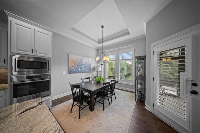 dining space with crown molding, baseboards, a notable chandelier, and dark wood-style floors