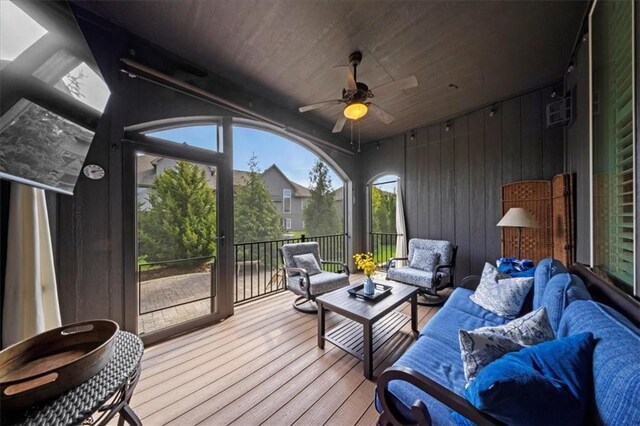 sunroom with a ceiling fan, a healthy amount of sunlight, and outdoor lounge area