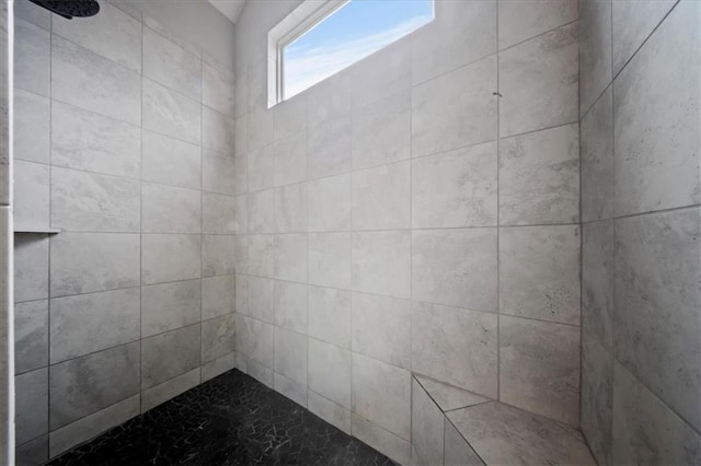 full bath featuring a tile shower