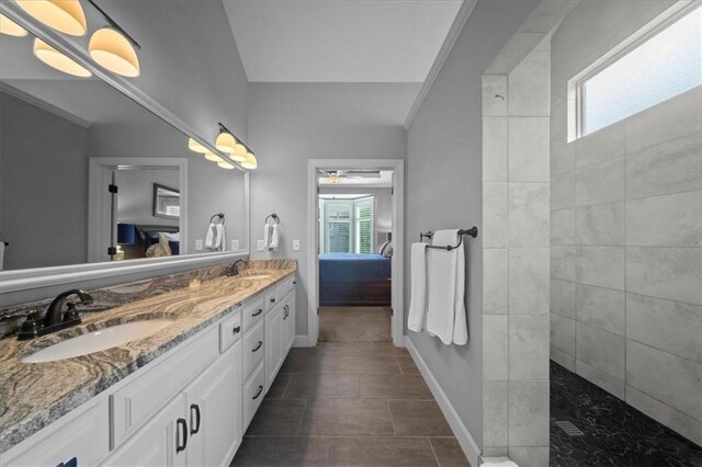 full bath featuring double vanity, a sink, a wealth of natural light, and ensuite bathroom
