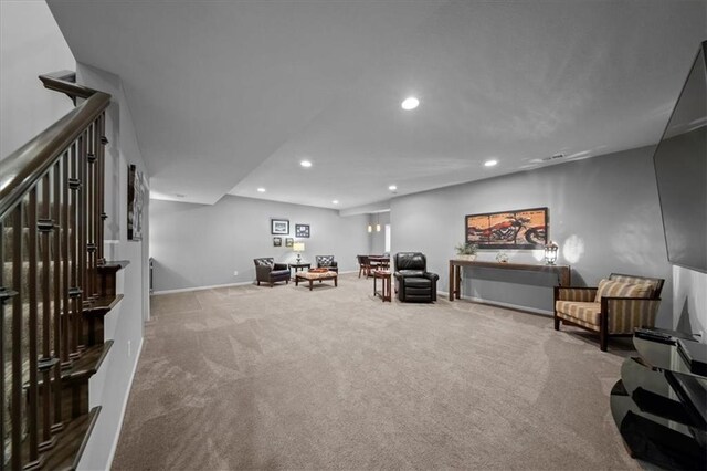 living area with recessed lighting, baseboards, and carpet