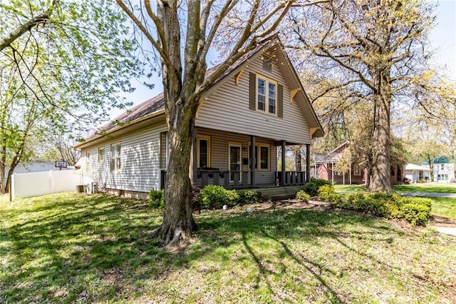 401 E Jackson St, Windsor, MO 65360 - rear view of house featuring fence, a porch, and a yard