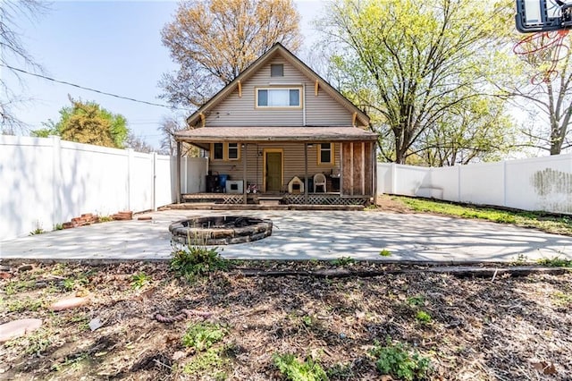 401 E Jackson St, Windsor, MO 65360 - back of house featuring a fenced backyard, an outdoor fire pit, and a patio