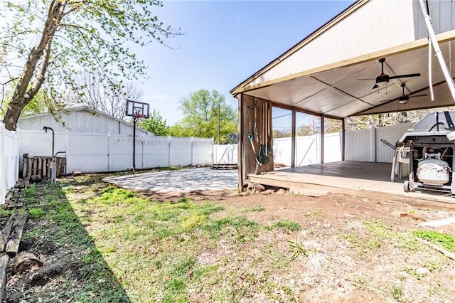 401 E Jackson St, Windsor, MO 65360 - view of yard featuring a fenced backyard, a ceiling fan, and a deck