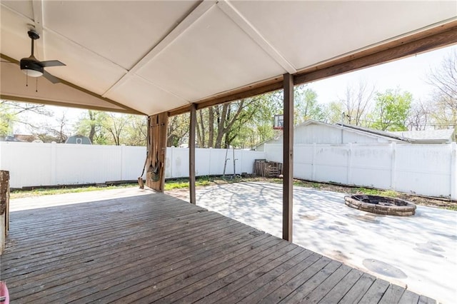 401 E Jackson St, Windsor, MO 65360 - wooden terrace with a fenced backyard, ceiling fan, an outdoor fire pit, and a patio