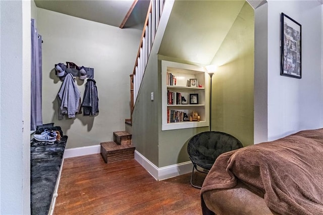 401 E Jackson St, Windsor, MO 65360 - corridor featuring stairs, wood finished floors, arched walkways, built in features, and baseboards