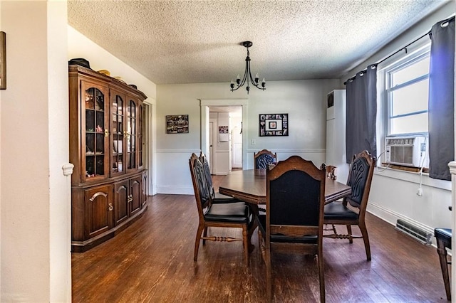 401 E Jackson St, Windsor, MO 65360 - dining area featuring a notable chandelier, cooling unit, dark wood-type flooring, and a textured ceiling