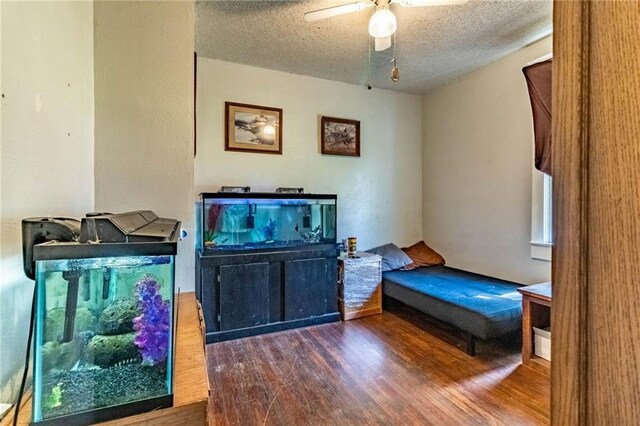 401 E Jackson St, Windsor, MO 65360 - bedroom featuring wood finished floors, a textured ceiling, and ceiling fan