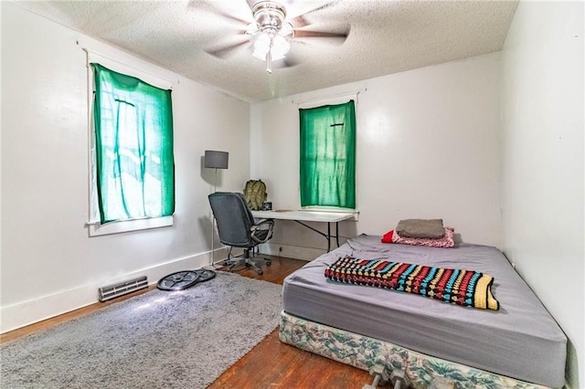 401 E Jackson St, Windsor, MO 65360 - bedroom with wood finished floors, a textured ceiling, and a ceiling fan