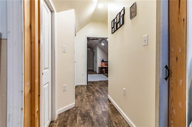 401 E Jackson St, Windsor, MO 65360 - corridor with lofted ceiling, dark wood-type flooring, and baseboards