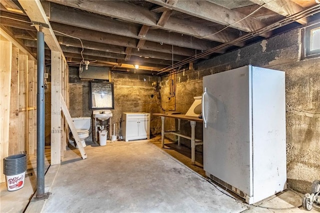 401 E Jackson St, Windsor, MO 65360 - unfinished basement with freestanding refrigerator and a sink
