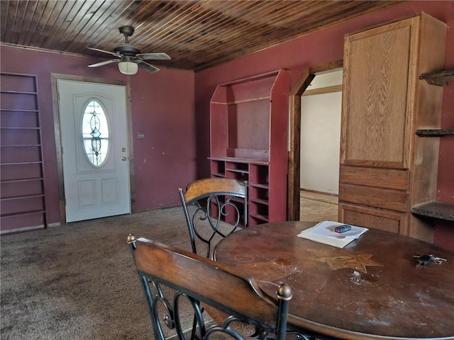 carpeted dining area featuring wood ceiling and a ceiling fan