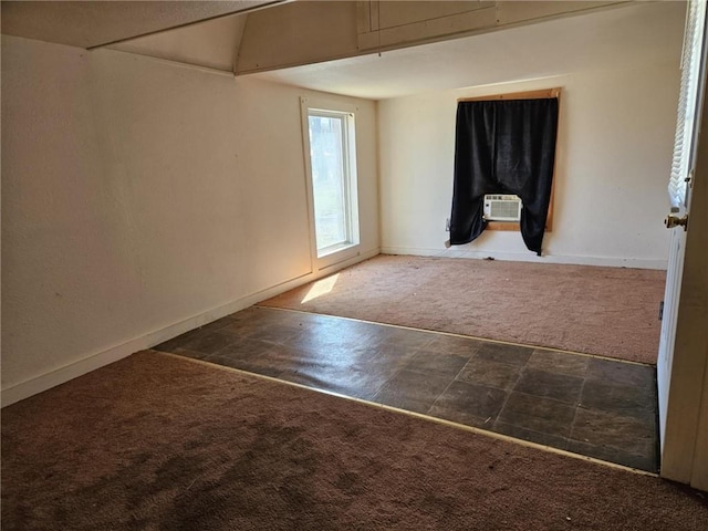 spare room featuring baseboards and carpet