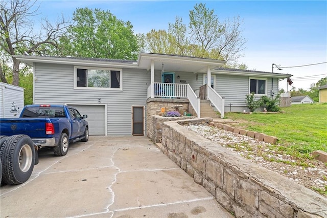 ranch-style house with concrete driveway, an attached garage, covered porch, and a front yard