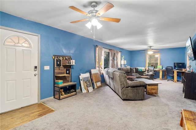 carpeted living area featuring a ceiling fan