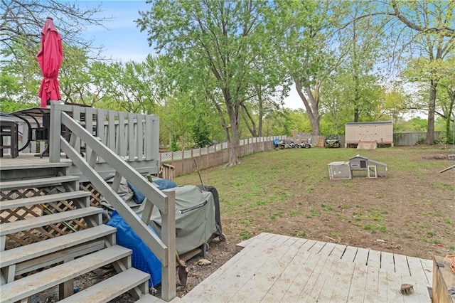 view of yard with an outdoor structure, fence, and a deck