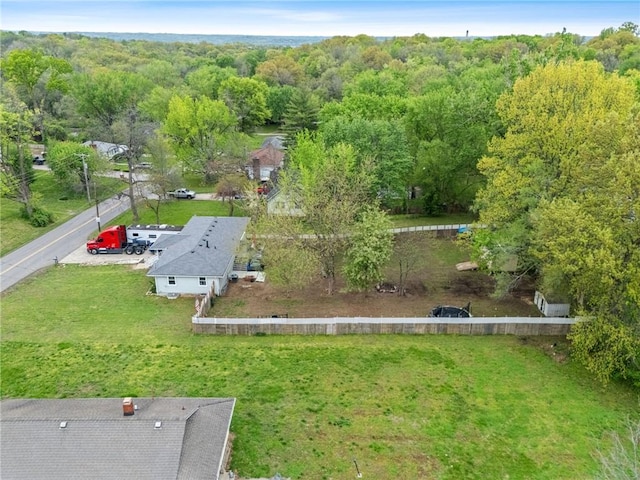 bird's eye view with a wooded view
