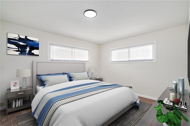 bedroom featuring baseboards and visible vents