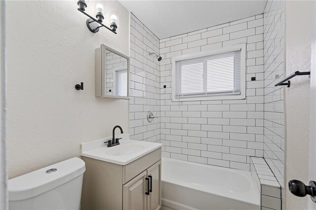 bathroom with vanity, shower / bathtub combination, and toilet