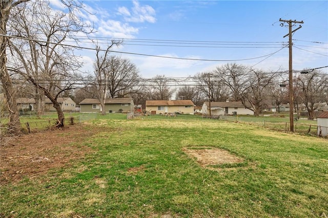 view of yard featuring fence and a residential view
