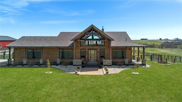 back of property featuring a lawn, fence, and roof with shingles