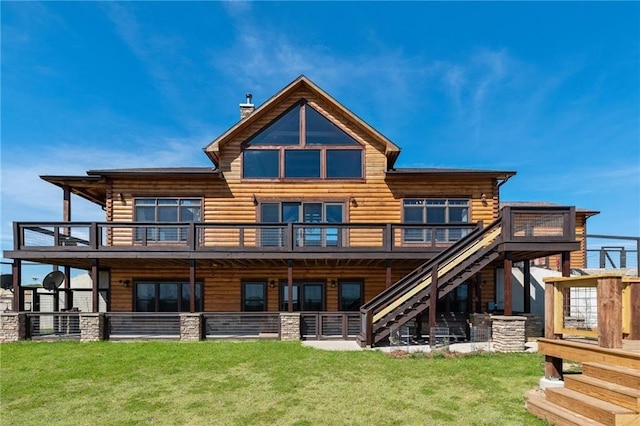 rear view of property featuring a yard, a deck, a chimney, and stairs