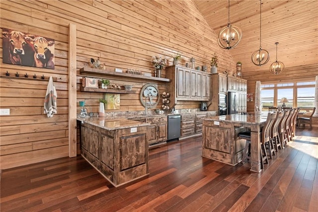 kitchen featuring an inviting chandelier, high vaulted ceiling, wood ceiling, dark wood finished floors, and appliances with stainless steel finishes