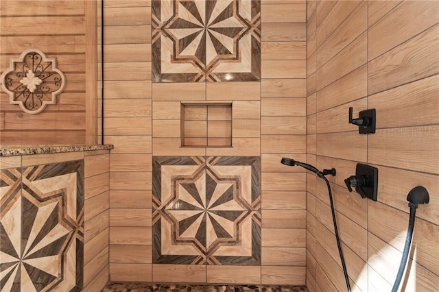interior details featuring tiled shower