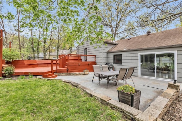 exterior space featuring a patio, a deck, a lawn, and a shingled roof