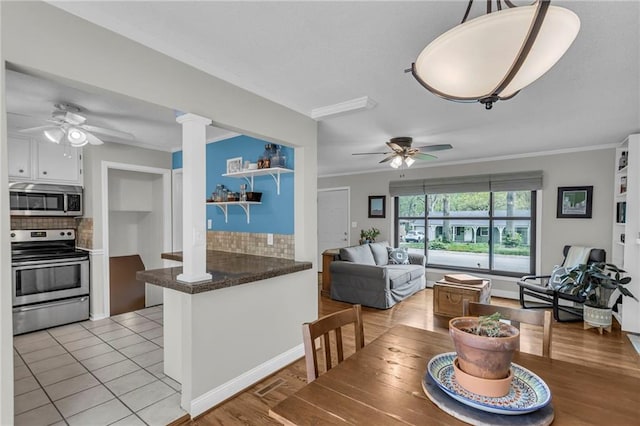 kitchen with ceiling fan, appliances with stainless steel finishes, and backsplash