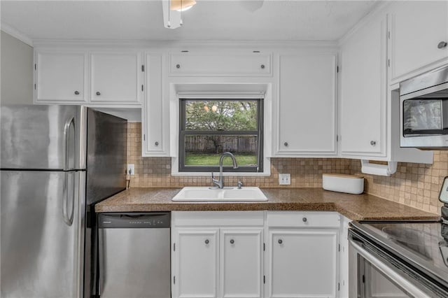 kitchen featuring a sink, white cabinetry, stainless steel appliances, and tasteful backsplash