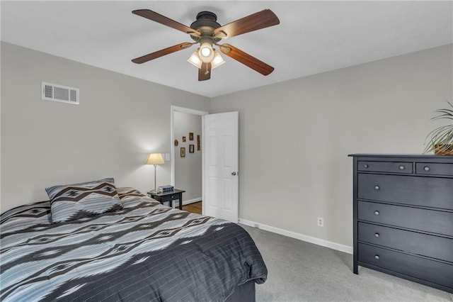 carpeted bedroom featuring visible vents, ceiling fan, and baseboards