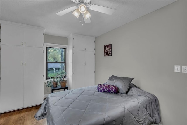 bedroom with wood finished floors and ceiling fan