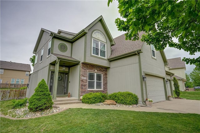 view of front of house with fence, a shingled roof, driveway, and a front yard