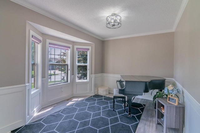 14108 Pine Valley Ct, Basehor, KS 66007 - sitting room with a textured ceiling, crown molding, a wainscoted wall, and a chandelier