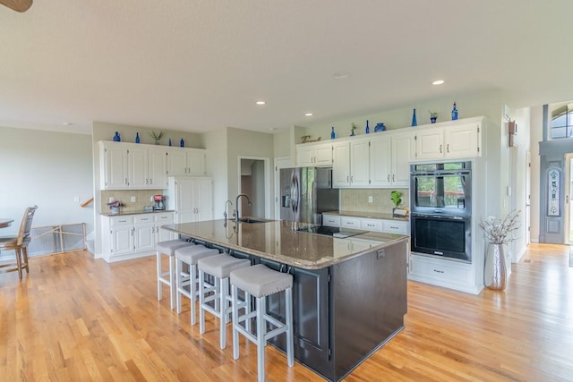 14108 Pine Valley Ct, Basehor, KS 66007 - kitchen with black appliances, a sink, decorative backsplash, light wood finished floors, and recessed lighting