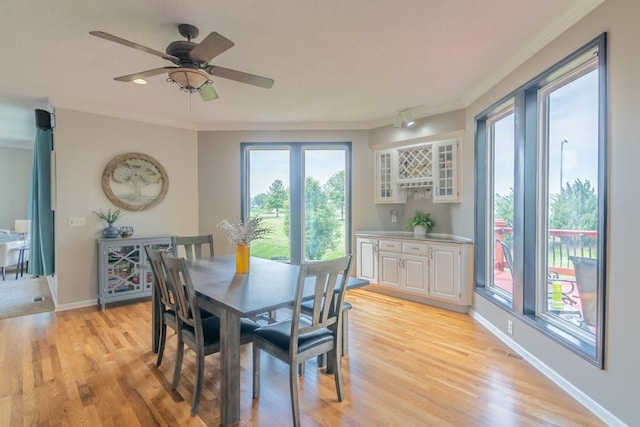 14108 Pine Valley Ct, Basehor, KS 66007 - dining room with crown molding, light wood-type flooring, baseboards, and a ceiling fan