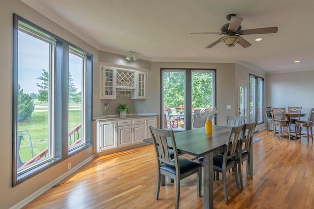 14108 Pine Valley Ct, Basehor, KS 66007 - dining room with crown molding, light wood finished floors, ceiling fan, recessed lighting, and baseboards
