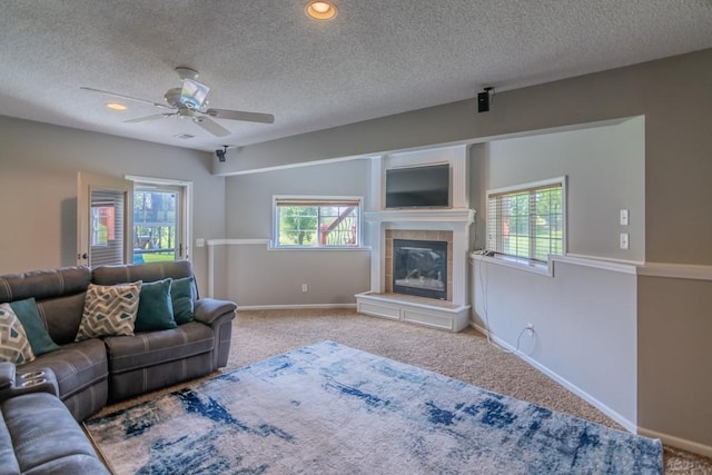 14108 Pine Valley Ct, Basehor, KS 66007 - living room featuring a fireplace, carpet, ceiling fan, baseboards, and a textured ceiling