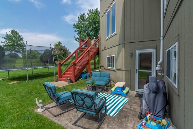 14108 Pine Valley Ct, Basehor, KS 66007 - view of patio with a trampoline, stairs, and outdoor lounge area