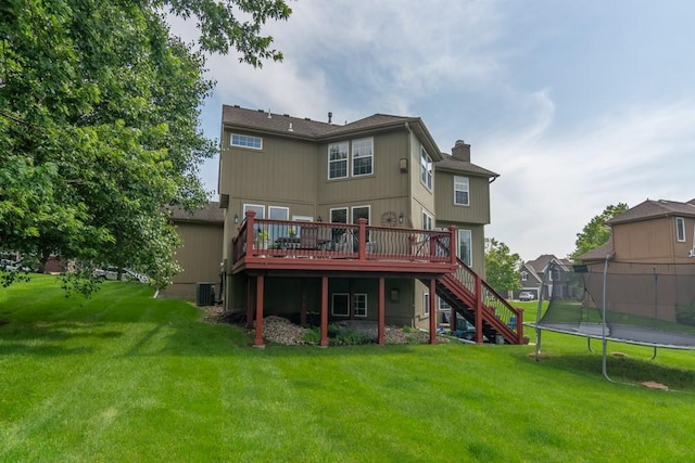 14108 Pine Valley Ct, Basehor, KS 66007 - rear view of property featuring stairs, a wooden deck, a trampoline, a chimney, and a lawn