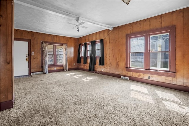 707 E 8th St, Trenton, MO 64683 - carpeted spare room with wooden walls, visible vents, and ceiling fan
