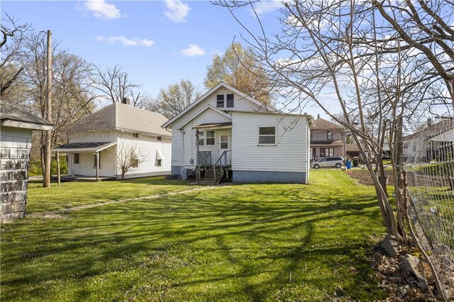 707 E 8th St, Trenton, MO 64683 - back of house featuring a yard and entry steps