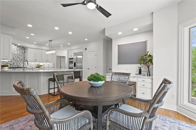 dining space with recessed lighting, a ceiling fan, baseboards, and wood finished floors
